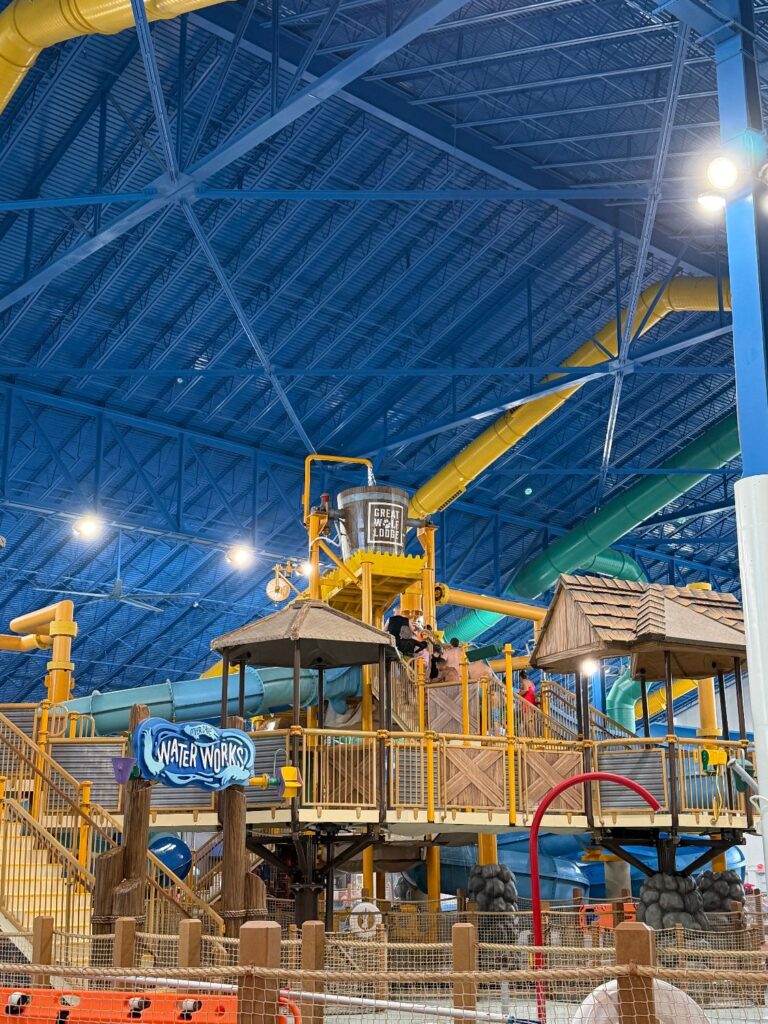 Resort water park with multiple slides, shallow play areas, and seating for families