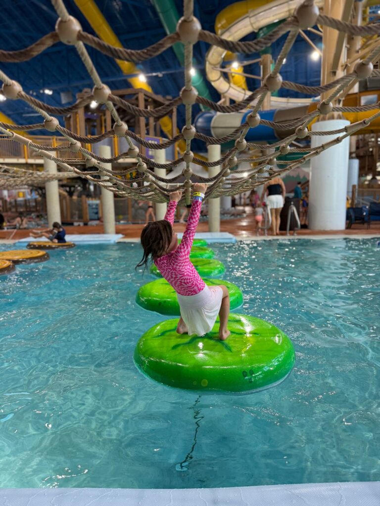 Kids playing in a family-friendly resort water park with colorful slides and pools